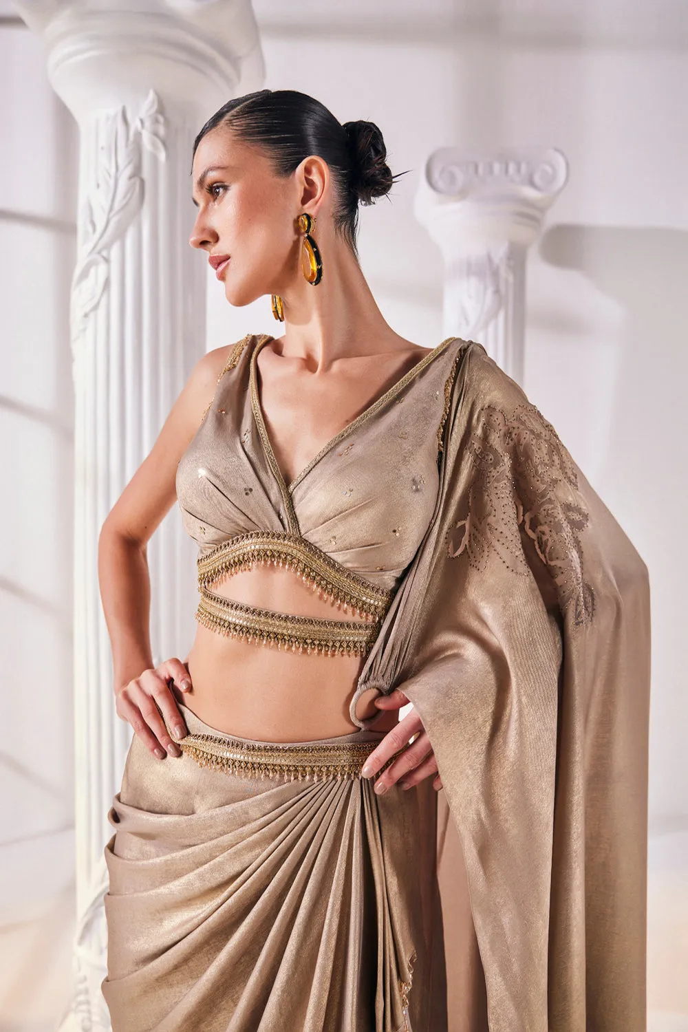 Mettalic Antique Gold Drape Saree With An Embellished Belt. It Is Paired With A Luxurious Metallic Blouse.