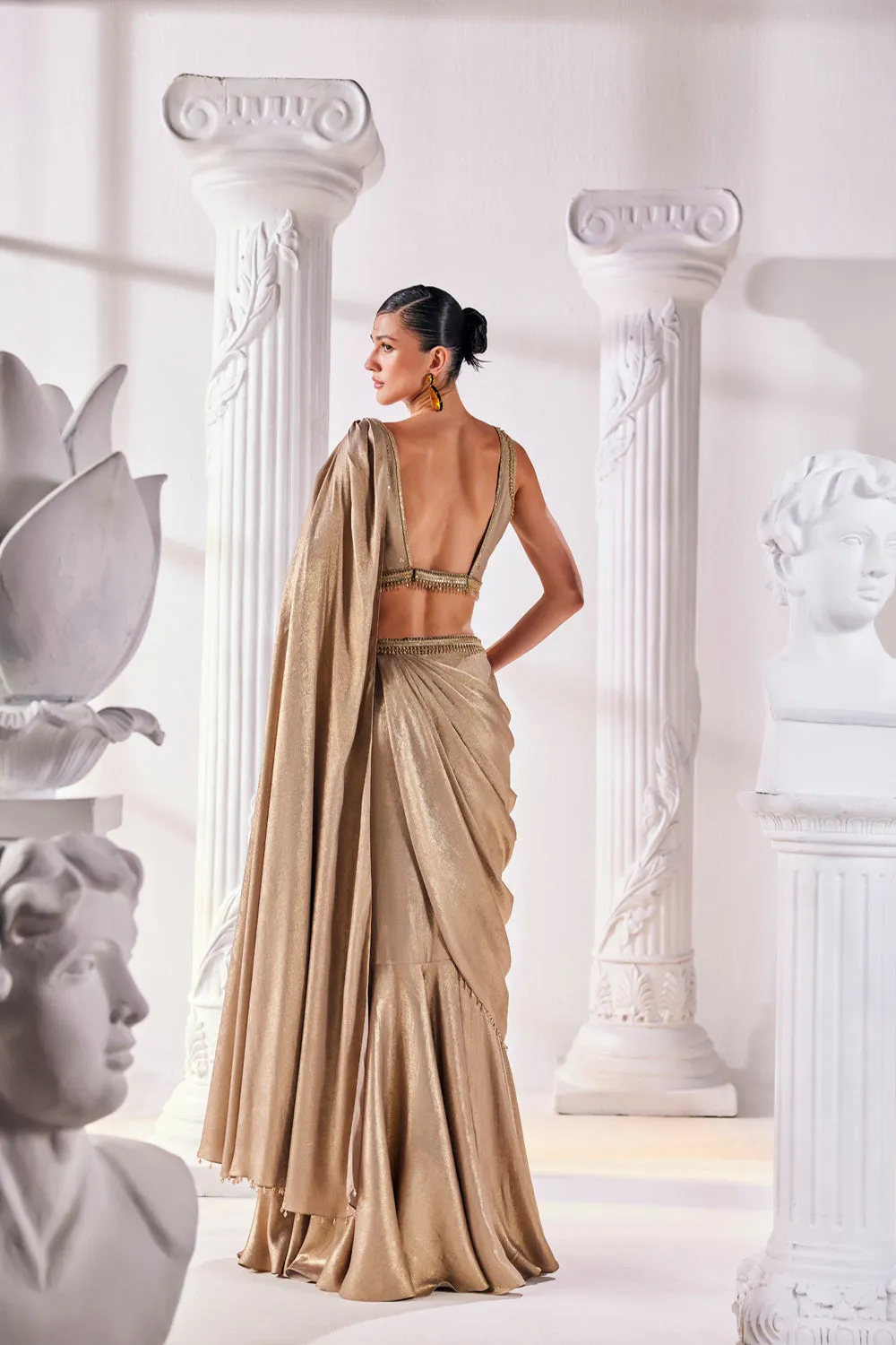 Mettalic Antique Gold Drape Saree With An Embellished Belt. It Is Paired With A Luxurious Metallic Blouse.